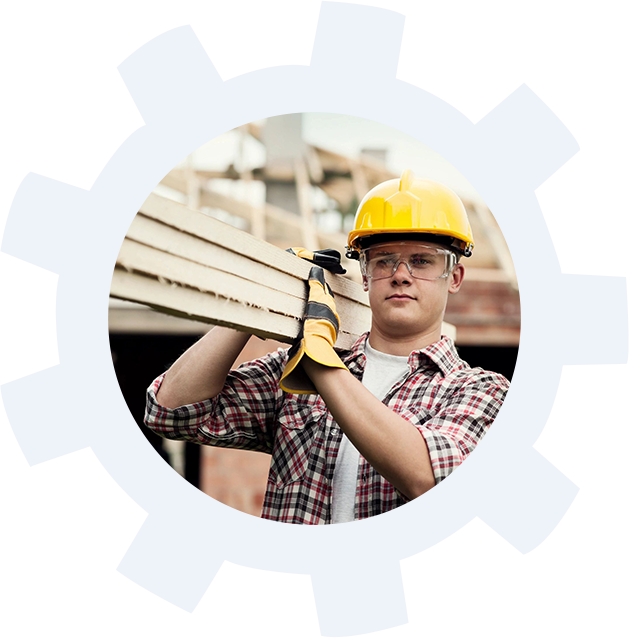 A man holding wood in his hands wearing hard hat.