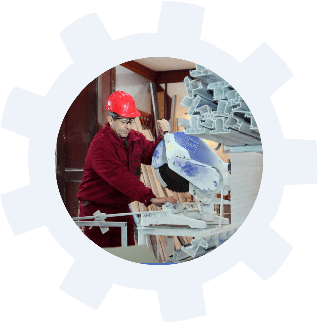 A man in red shirt and hard hat working on a machine.